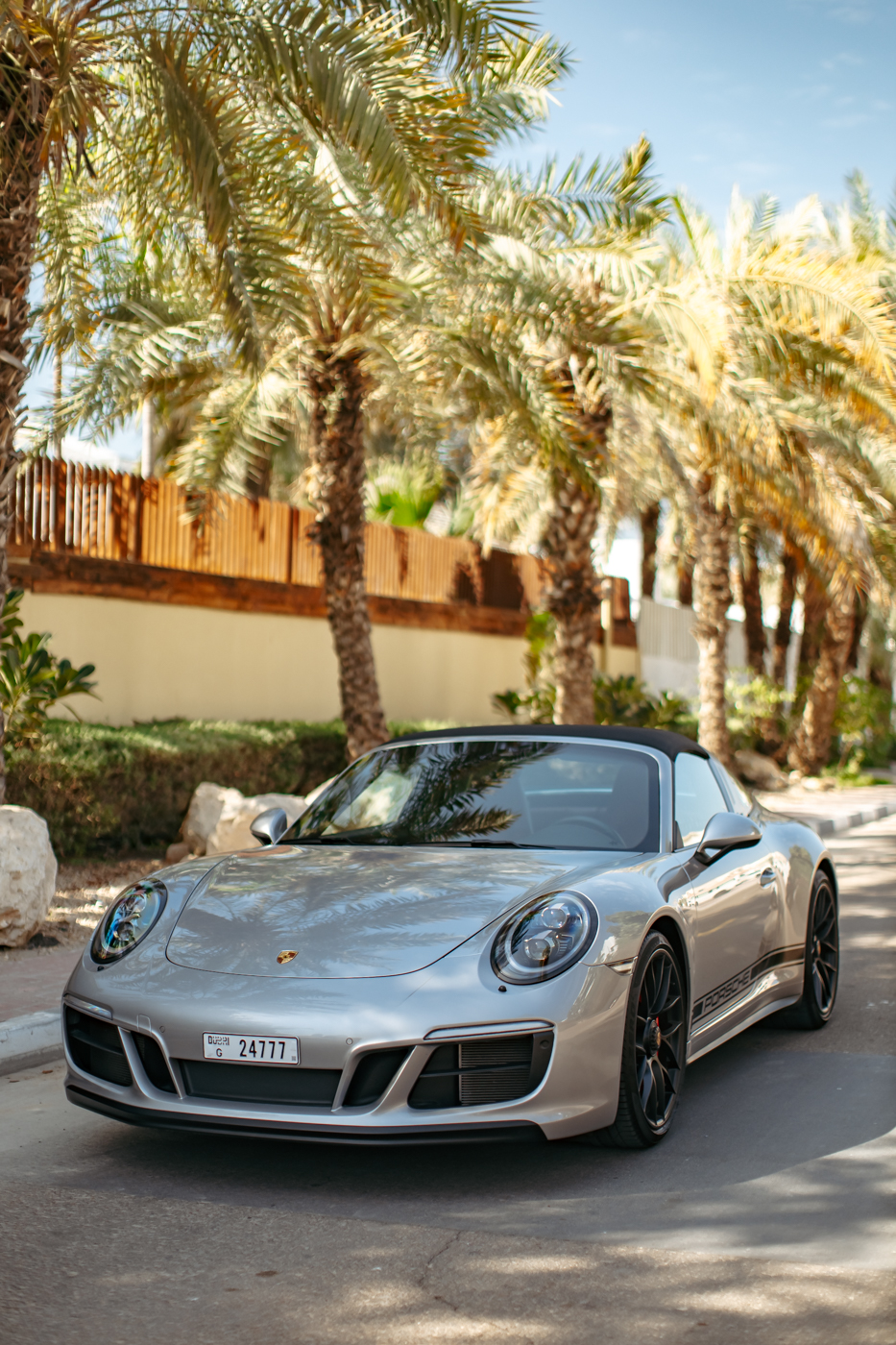 2019 Porsche 911 Carrera Targa GTS silver parked on a Dubai street with palm trees